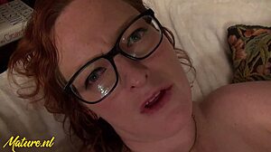 Glasses-wearing milf KD Morgan enjoys fingering her hairless clit