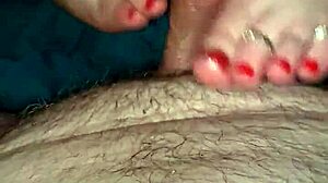 A foot fetish wife slides her foot over her man’s erect penis and jerks it off