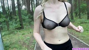 Caucasian woman is putting her naked body and her bouncing tits on display, she exercises in the park