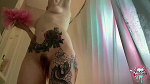 Tattooed blonde's sensual bath captured in slow motion